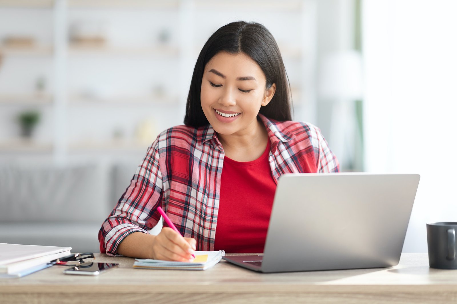 A learner thinking through a task while studying at a laptop