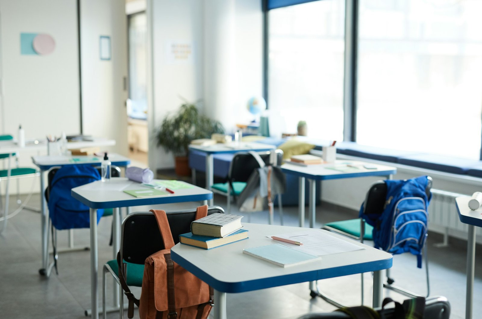 A classroom with desks, chairs, and a whiteboard