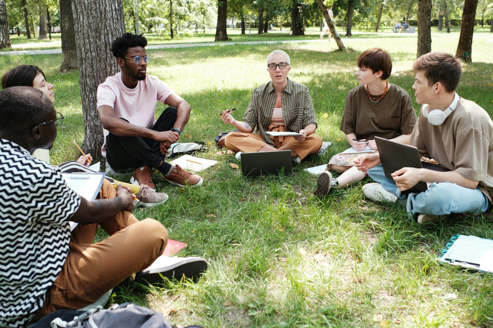 Teacher with students studying outdoors