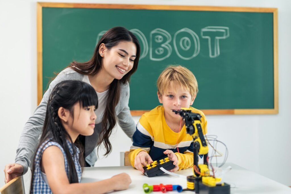 Adorable student learn with teacher in classroom at elementary school.