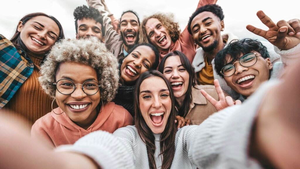 Multicultural community of young people smiling together at camera