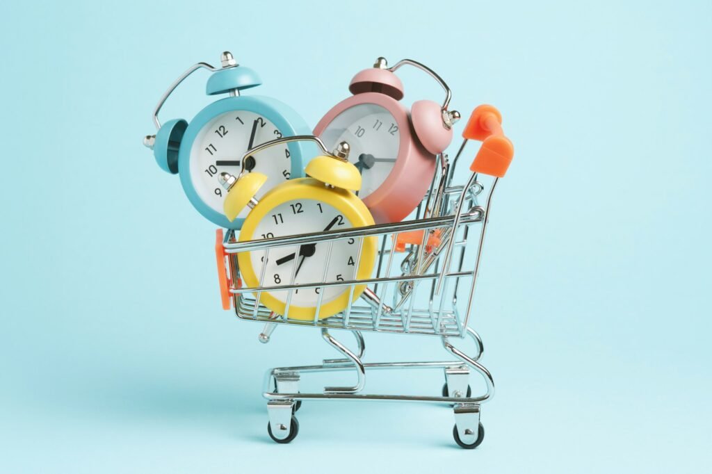 Three alarm clocks of different colors in a shopping cart.