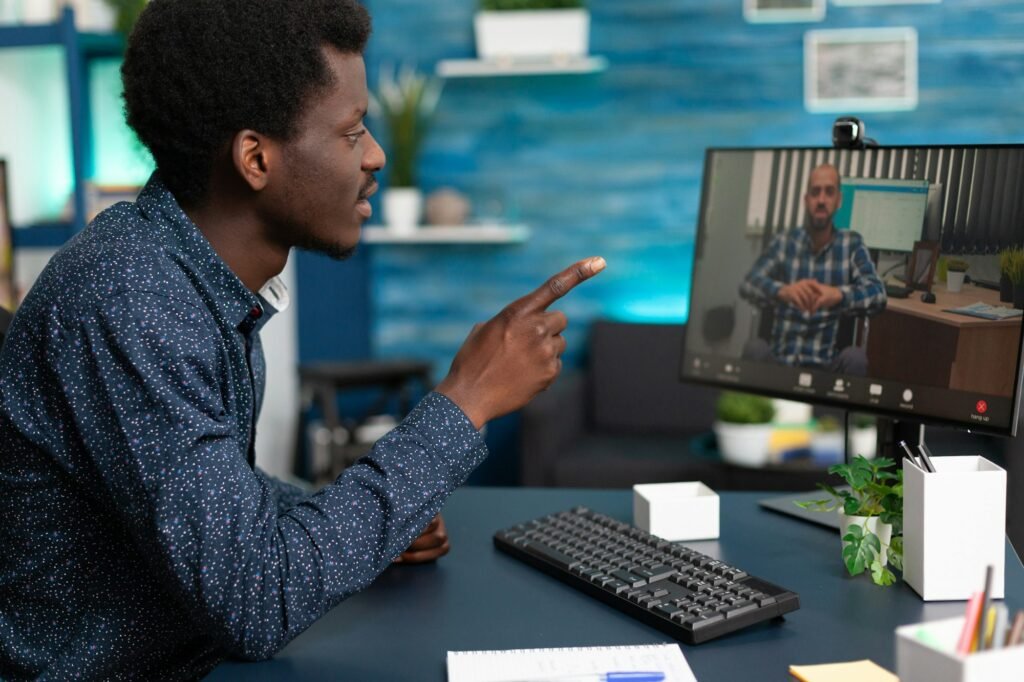 Black man talking with remote disabled handicap teacher