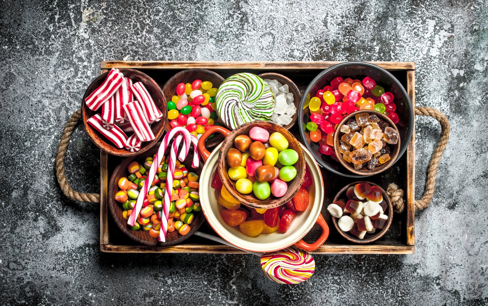 sweets candy, candied fruits with marshmallow and jelly on a wooden tray.