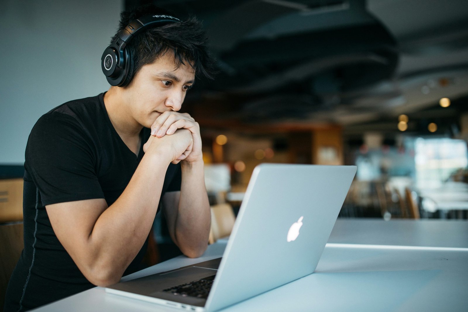 Focused learner wearing headphones at a laptop engaging in microlearning for teachers using short, targeted lessons.