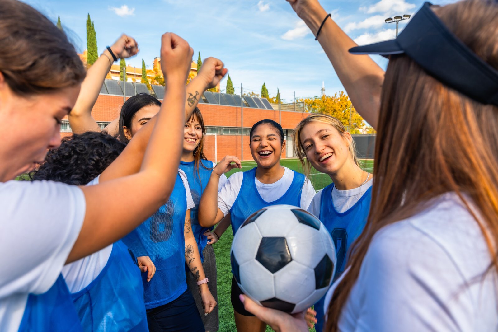 Teammates celebrating and supporting one another on a soccer field