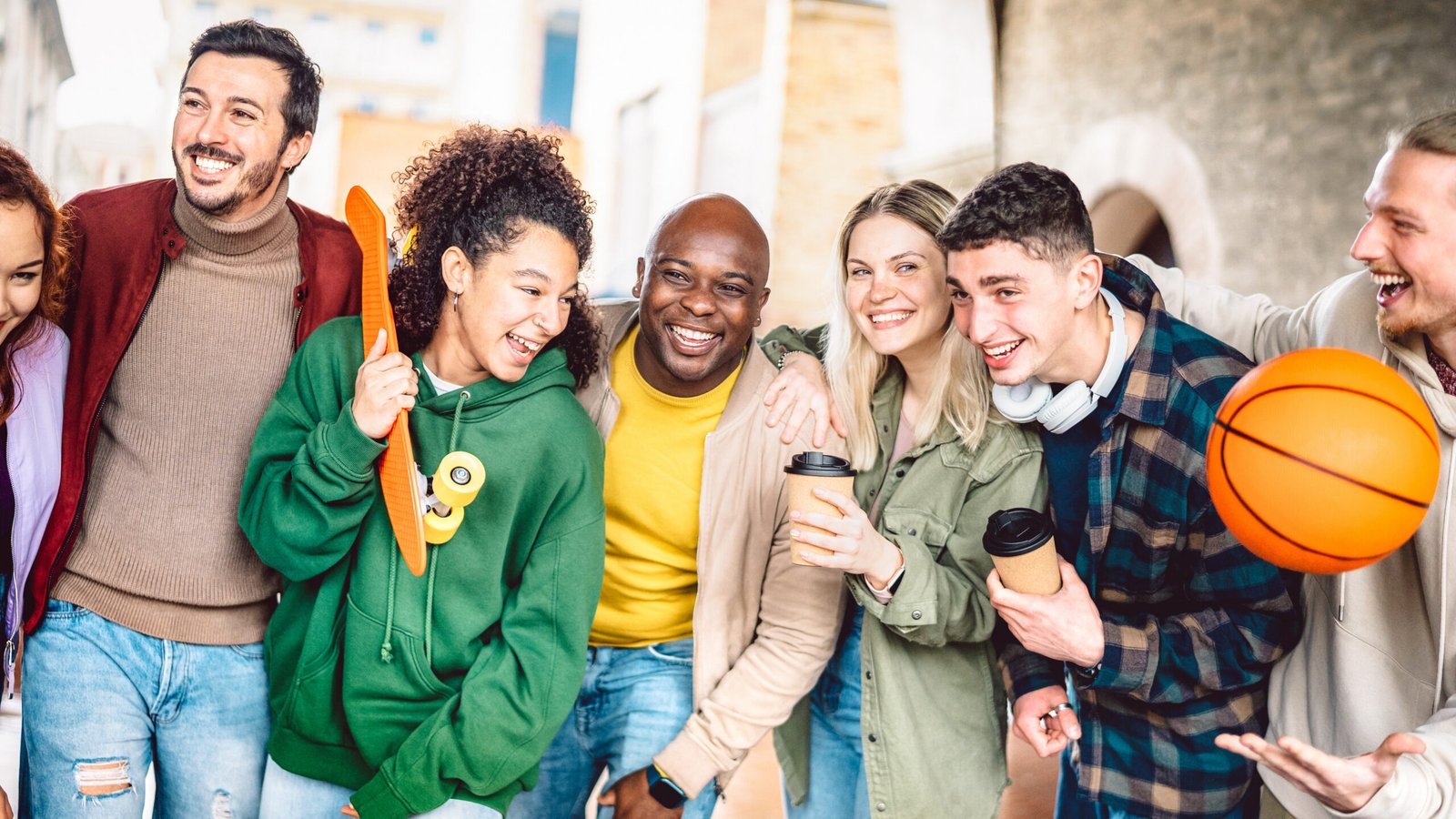 A group of teenagers with different interests smiling together outdoors