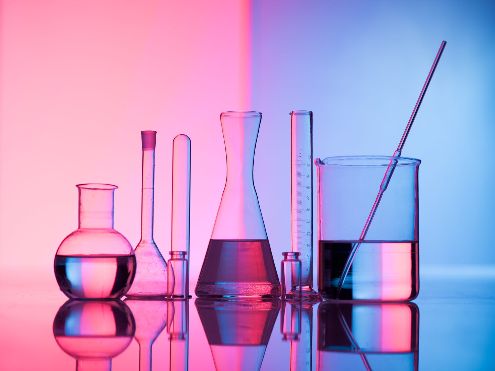 Laboratory glassware with colored liquids for scientific investigation