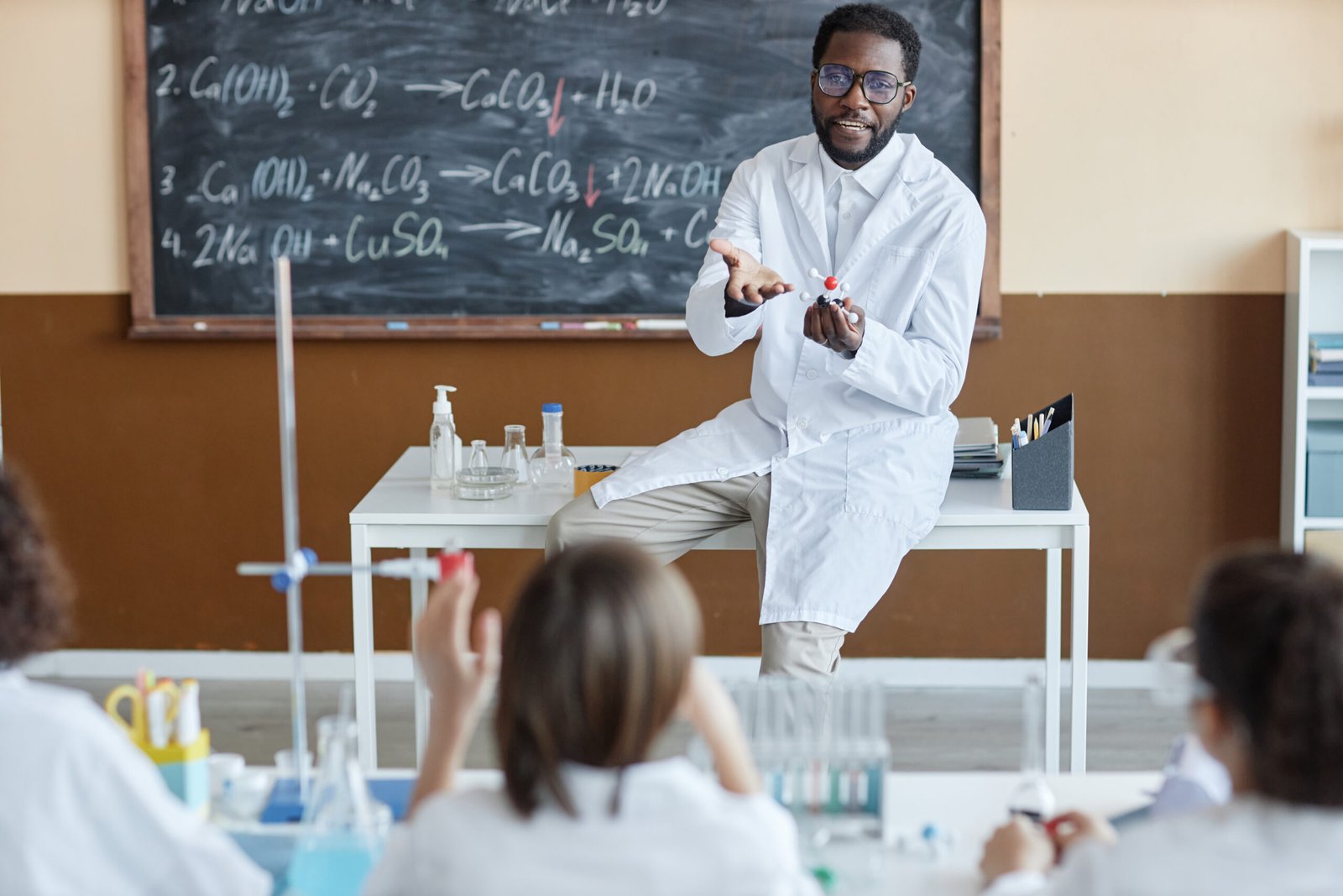 A teacher demonstrating a science concept to a class