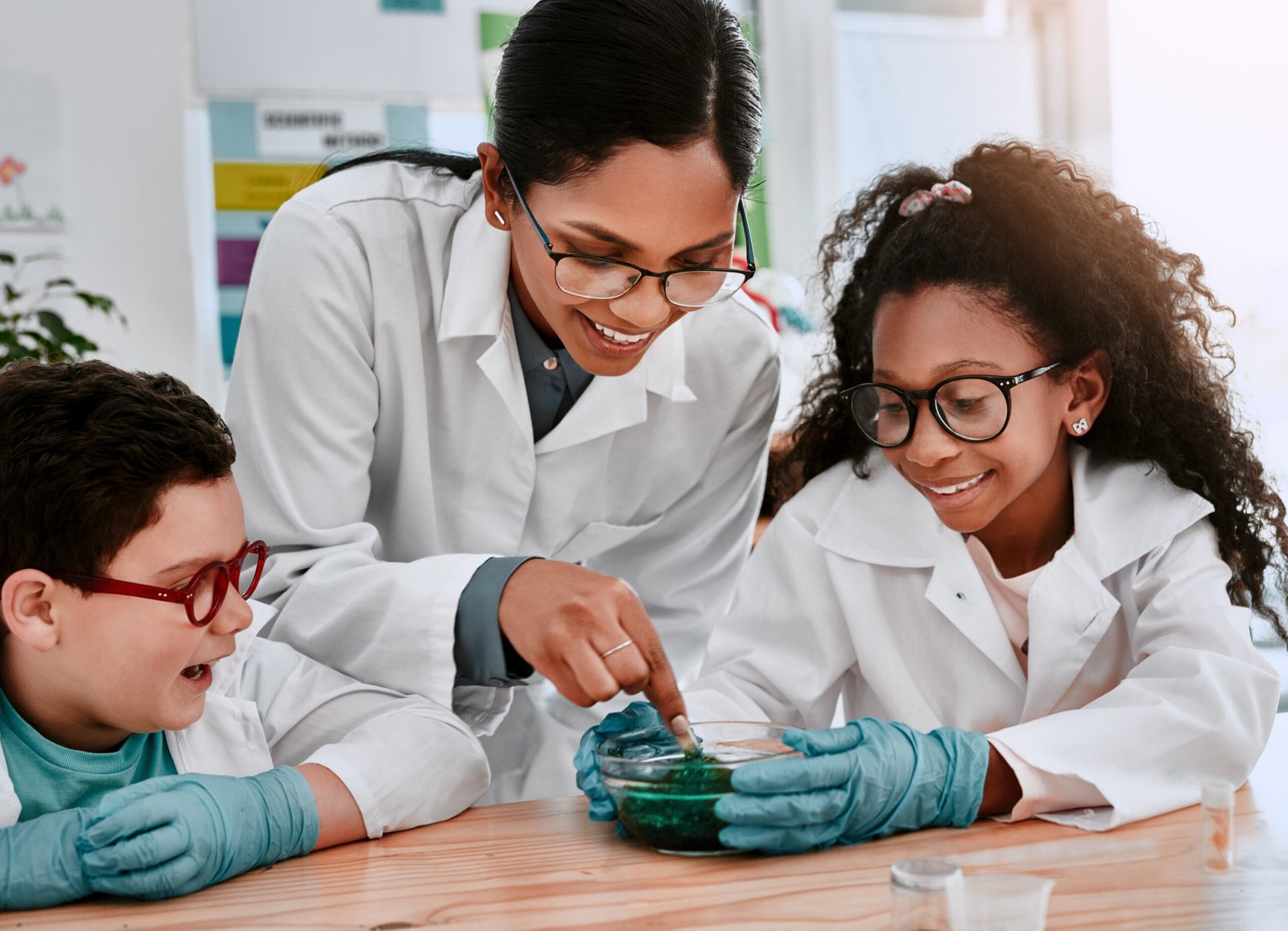 A teacher guiding students through a science experiment